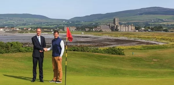 HM of King William’s College Joss Buchanan & Golf Pro Dave Adams on the Links with the English boarding school in the background | Dickinson School Consulting